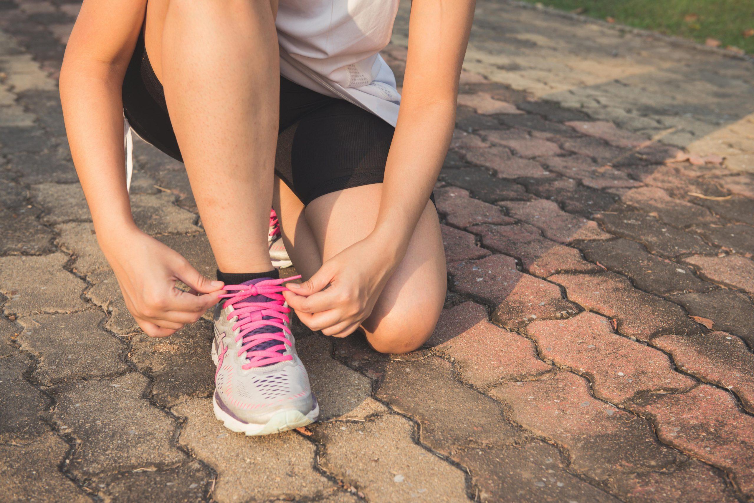 A person tying their shoes
