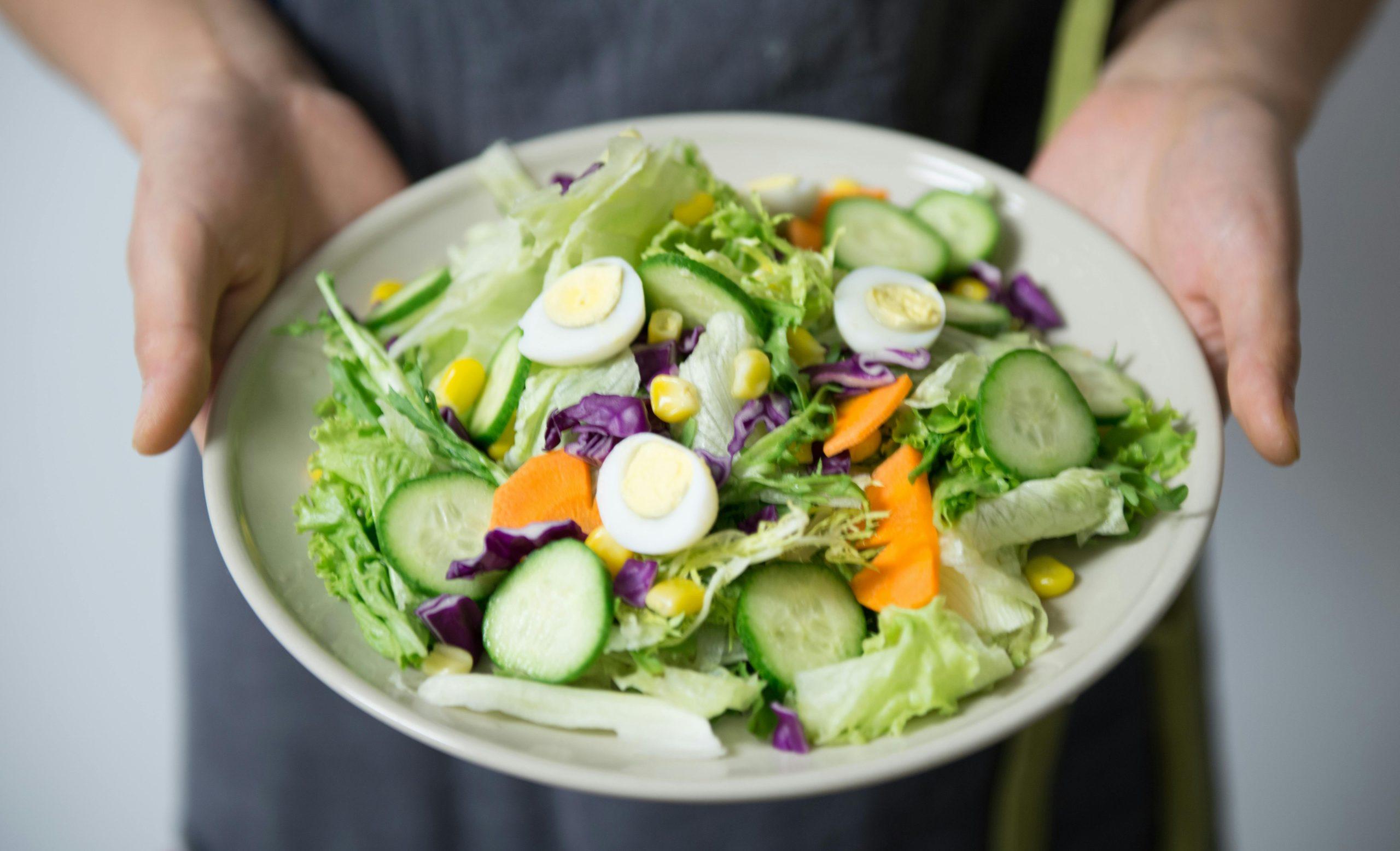A person holding a salad