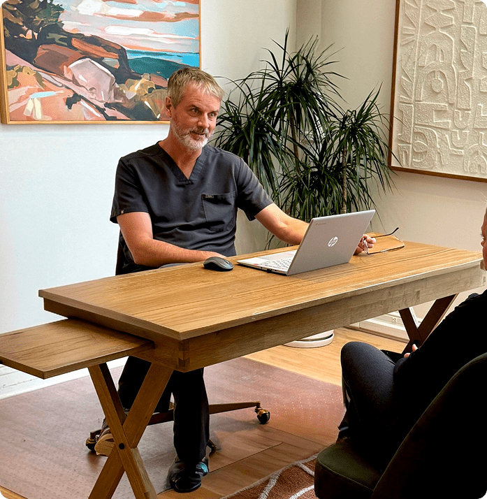 Doctor conducting a patient intake consultation during an in-person medical visit at a clinic in Edina, Minnesota.
