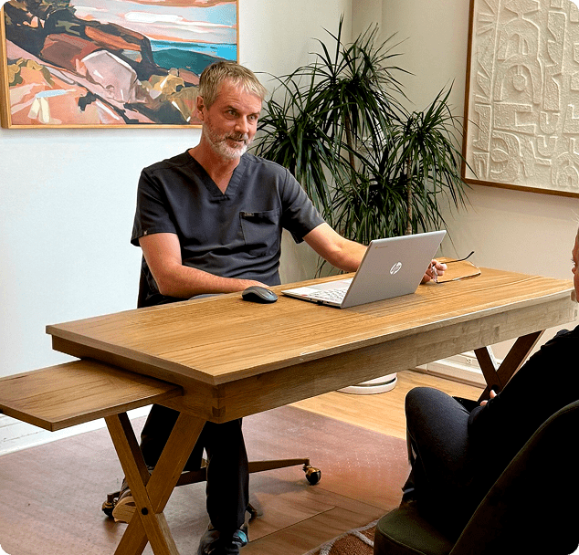 Medical provider at Lite Medical conducting a private consultation with a patient in a comfortable clinic office setting.