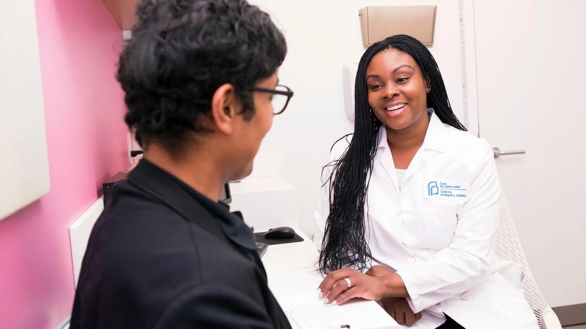 Physician reviewing laboratory results with middle-aged patient in Rochester medical clinic