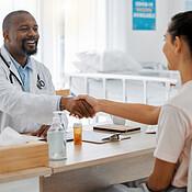 Physician reviewing metabolic laboratory results and discussing compounded tirzepatide safety with adult patient in Bloomington clinic